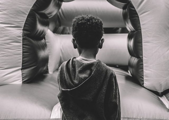 boy in gray sweater sitting