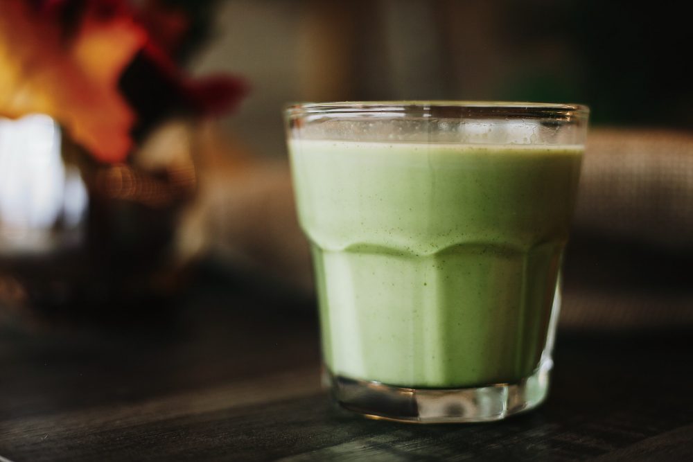 green liquid in clear drinking glass