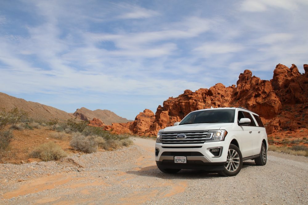 parked white ford suv