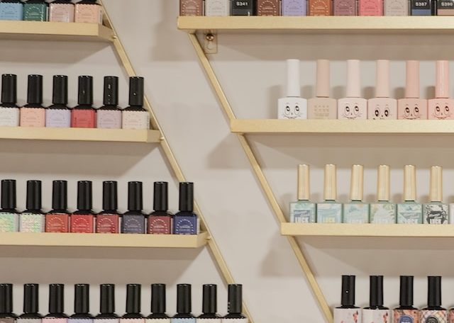 white and black bottles on brown wooden shelf