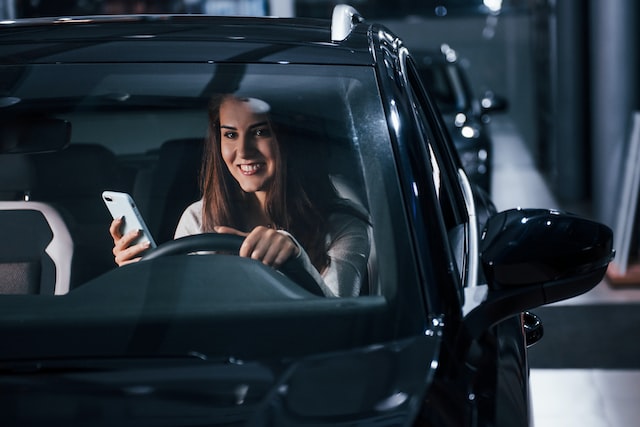 young woman is inside of automobile